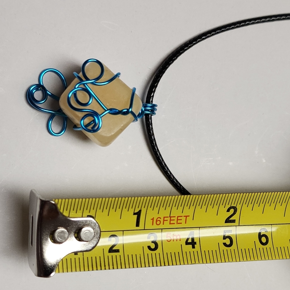 Handmade wire wrap stone pendant with cord.